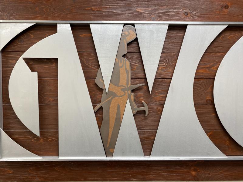GWC metal sign with welder figure in the General Welding Company shop
